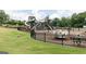 A large playground with multiple play structures is surrounded by a secure fence at 602 Belshire Dr, Acworth, GA 30102