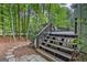 Wooden deck steps lead to a private wooded backyard, perfect for outdoor enjoyment and relaxation at 1214 Weatherstone Way, Peachtree City, GA 30269