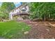 Spacious, lush, backyard showcases the home with multi-tiered decks and walkout basement at 1214 Weatherstone Way, Peachtree City, GA 30269