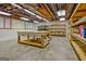 Unfinished basement featuring large workbench and shelving, ideal for a workshop or storage at 1214 Weatherstone Way, Peachtree City, GA 30269