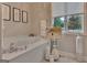 Bathroom with jetted tub, modern fixtures, and natural light from the window at 1214 Weatherstone Way, Peachtree City, GA 30269