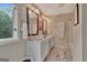 Bathroom with dual sinks, white cabinets and a large window at 1214 Weatherstone Way, Peachtree City, GA 30269