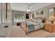 Bright bedroom features a ceiling fan, window, and comfortable wooden furnishings at 1214 Weatherstone Way, Peachtree City, GA 30269