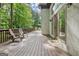 Spacious deck features wood flooring, railing, chairs and overlooks a serene wooded area at 1214 Weatherstone Way, Peachtree City, GA 30269