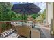 Comfortable wicker furniture, a large umbrella and wood railing adorn this large deck at 1214 Weatherstone Way, Peachtree City, GA 30269