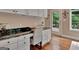 Desk area with white cabinets and black countertop near an outside door at 1214 Weatherstone Way, Peachtree City, GA 30269