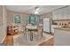 Cozy dining area with white cabinets, granite counters and views of a wooded lot at 1214 Weatherstone Way, Peachtree City, GA 30269