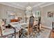 Formal dining room with a chandelier, wooden furniture, and a patterned rug, perfect for entertaining guests at 1214 Weatherstone Way, Peachtree City, GA 30269