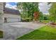 Long driveway showing garage access, landscaping, and mature shade trees at 1214 Weatherstone Way, Peachtree City, GA 30269
