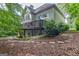 Back exterior view showing the walkout basement, wooded backyard and upper deck at 1214 Weatherstone Way, Peachtree City, GA 30269