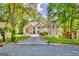 Stately two-story home boasts a sprawling driveway, lush landscaping, and a tranquil wooded setting at 1214 Weatherstone Way, Peachtree City, GA 30269