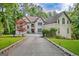 Beautiful two-story home with a long driveway, well-maintained landscaping, and surrounded by mature trees at 1214 Weatherstone Way, Peachtree City, GA 30269