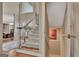 Elegant foyer features a staircase with wood and white accents and views to the dining room at 1214 Weatherstone Way, Peachtree City, GA 30269