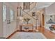 Welcoming foyer featuring a decorative front door, wooden floors, and a staircase with wood and white railings at 1214 Weatherstone Way, Peachtree City, GA 30269