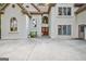 The front entry has double doors, detailed trim, and a seating area surrounded by mature plants at 1214 Weatherstone Way, Peachtree City, GA 30269