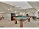 Spacious game room with a pool table, TV, seating, and neutral decor at 1214 Weatherstone Way, Peachtree City, GA 30269