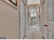 Hallway with white walls, white doors, and view of a chandelier and arched window at 1214 Weatherstone Way, Peachtree City, GA 30269