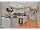 Well-lit kitchen with white cabinets, stainless steel appliances, granite countertops and hardwood flooring at 1214 Weatherstone Way, Peachtree City, GA 30269