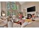 Inviting living room with large windows, cozy sofas, a fireplace, and a view of the well-maintained backyard at 1214 Weatherstone Way, Peachtree City, GA 30269