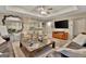 Comfortable living room featuring tray ceilings, a chess table, and a pass-through to the kitchen at 1214 Weatherstone Way, Peachtree City, GA 30269