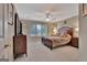 Spacious bedroom with a large window view and wood furniture at 1214 Weatherstone Way, Peachtree City, GA 30269