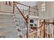 Open staircase featuring wood and white railing overlooking the living room at 1214 Weatherstone Way, Peachtree City, GA 30269