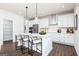 Kitchen island with barstool seating, modern pendant lighting, and a white countertop at 608 Belshire Dr, Acworth, GA 30102