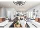 Open-concept living room with modern lighting, views into the kitchen, and hardwood flooring at 608 Belshire Dr, Acworth, GA 30102