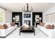 Elegant living room with black accent wall, fireplace, stylish lighting, and comfortable seating at 608 Belshire Dr, Acworth, GA 30102