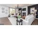 Bright living room with a fireplace, a modern chandelier, and neutral-toned furniture at 608 Belshire Dr, Acworth, GA 30102