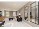 Comfortable living room with neutral tones, large windows, and modern decor including unique mirrors and artwork at 608 Belshire Dr, Acworth, GA 30102
