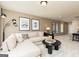 Comfortable living area showcasing a sectional sofa, a modern coffee table, and stylish decor with natural light at 608 Belshire Dr, Acworth, GA 30102