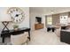 Living area featuring a desk area, a large clock, and a comfy sofa with lots of natural light from multiple windows at 608 Belshire Dr, Acworth, GA 30102