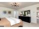 Elegant main bedroom with a modern chandelier, stylish décor, and a view into the adjacent room at 608 Belshire Dr, Acworth, GA 30102