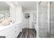 Spacious bathroom with double vanities, a glass shower, and luxury vinyl plank flooring at 502 Regency Trl, Acworth, GA 30102