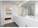 White double vanity in a modern bathroom featuring a large mirror and views to the bedroom at 502 Regency Trl, Acworth, GA 30102