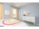 Bright bedroom with light blue walls, white trim, a colorful bedspread, and sunny windows at 502 Regency Trl, Acworth, GA 30102