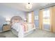Bright bedroom with blue walls, white trim, a colorful bedspread, and two sunny windows at 502 Regency Trl, Acworth, GA 30102