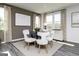 Dining area with contemporary chairs, a dark table, and large windows with patterned curtains at 502 Regency Trl, Acworth, GA 30102