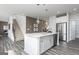 Spacious kitchen with a white island, stainless steel appliances, and an open view of staircase at 502 Regency Trl, Acworth, GA 30102
