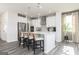 Well-lit kitchen with stainless appliances, a breakfast bar with pendant lights, and modern gray flooring at 502 Regency Trl, Acworth, GA 30102