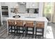 Stylish kitchen boasts sleek white cabinets, a large island, and modern pendant lighting at 502 Regency Trl, Acworth, GA 30102