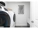 Modern laundry room with front load washer and dryer, and luxury vinyl plank flooring at 502 Regency Trl, Acworth, GA 30102