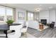 Bright, open-concept living room featuring a fireplace, wood floors, and large windows at 502 Regency Trl, Acworth, GA 30102