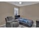 Comfortable bedroom with a cozy recliner, a plush bed, and soft, neutral colors for a relaxing atmosphere at 11367 Vinea Ln, Hampton, GA 30228