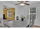 Open concept dining area with wood table and a ceiling fan, seamlessly connected to other spaces at 11367 Vinea Ln, Hampton, GA 30228