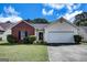 Charming single-story home featuring a brick facade and a two-car garage with manicured lawn at 11367 Vinea Ln, Hampton, GA 30228