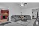 Comfortable living room features a gray sofa and seamless flow to an adjacent kitchen at 11367 Vinea Ln, Hampton, GA 30228