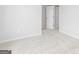 A bright bedroom with light grey carpet, baseboards and walls with a white door at 407 Newland Way, Acworth, GA 30102