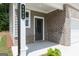 Inviting front porch with brick accents, covered entrance, and a modern door with sidelight at 407 Newland Way, Acworth, GA 30102